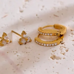 Misgraceful Huggie & Stud Earring Set - Gold on marble surface